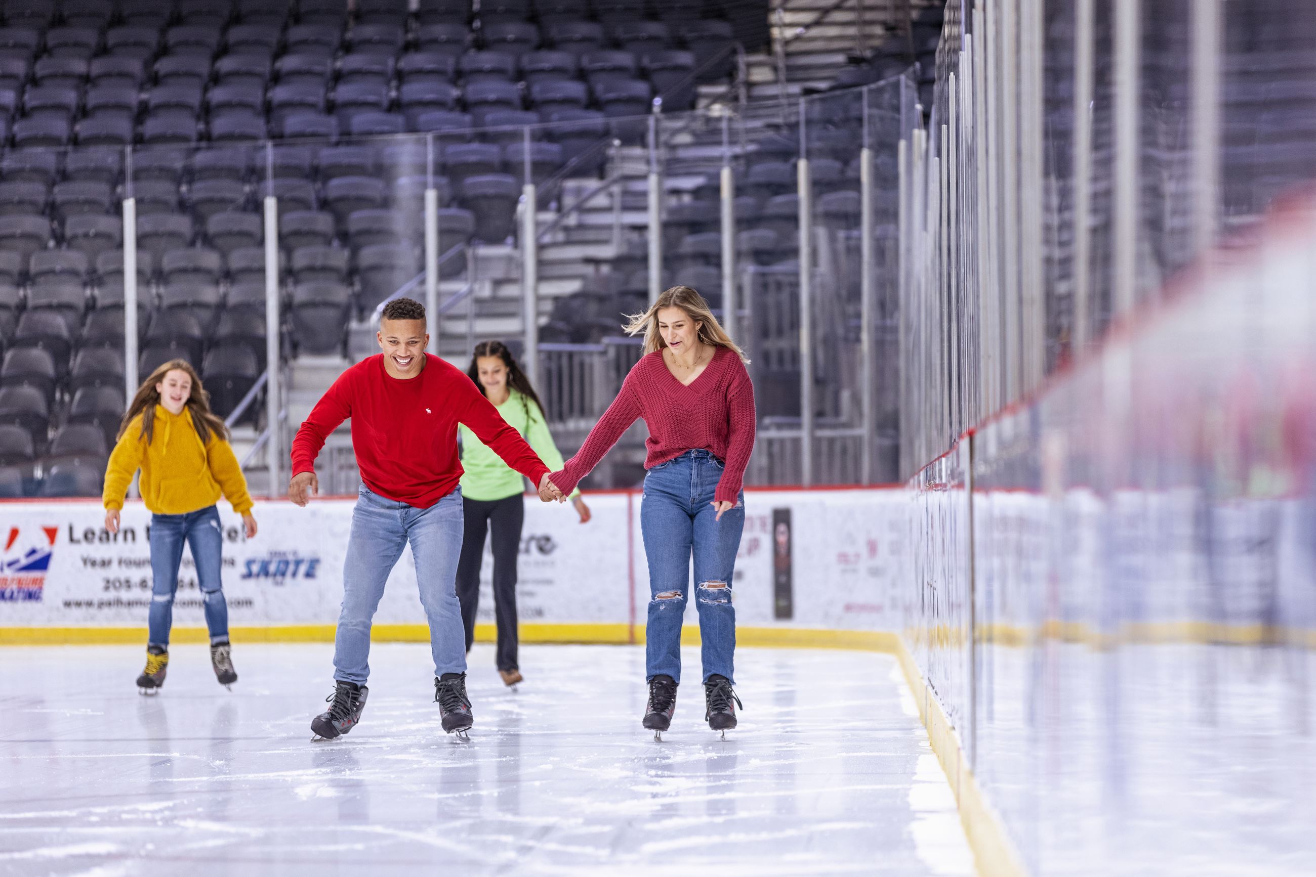 Young man and woman ice skating